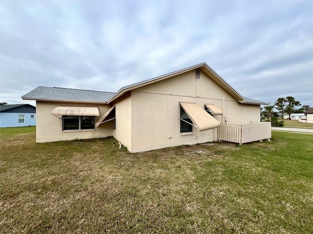 rear view of property featuring a yard