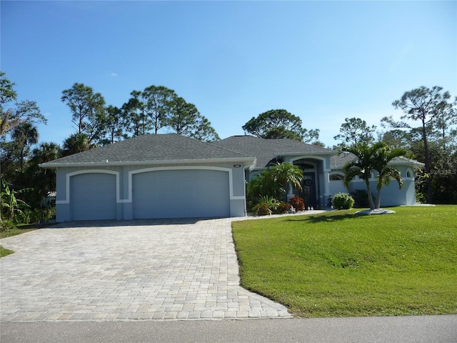 single story home with a garage and a front lawn