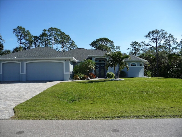 ranch-style home featuring a front yard and a garage