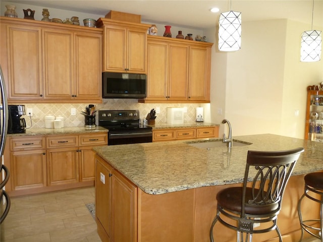 kitchen with decorative light fixtures, black electric range oven, a center island with sink, and sink