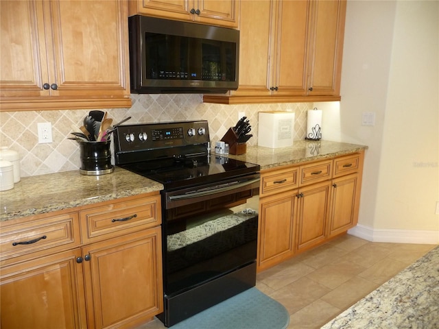 kitchen featuring decorative backsplash, black electric range oven, light stone counters, and light tile patterned floors