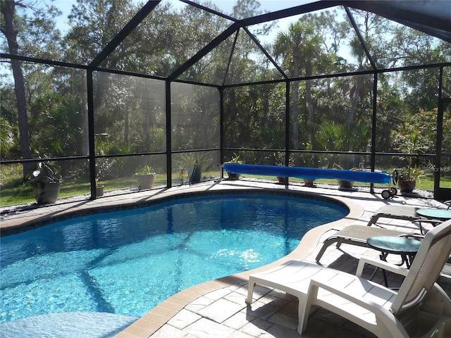 view of swimming pool with a lanai and a patio