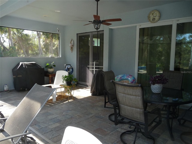 view of patio featuring ceiling fan and a grill