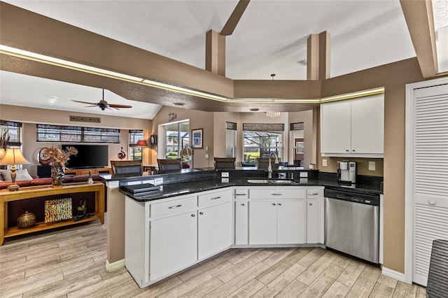 kitchen with stainless steel dishwasher, ceiling fan, white cabinetry, and sink