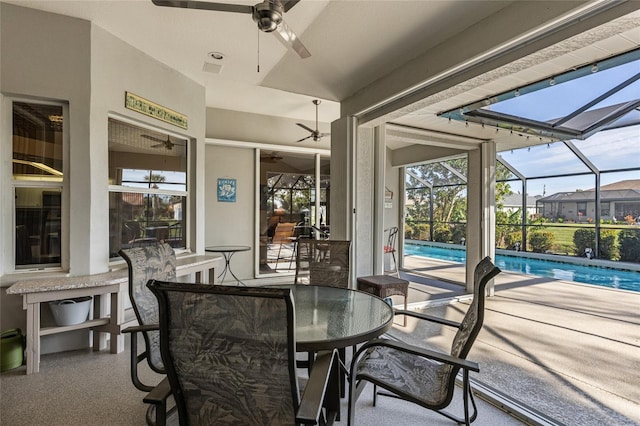 sunroom / solarium with ceiling fan and a pool