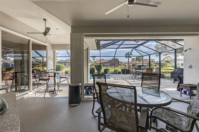 view of patio / terrace featuring ceiling fan and a lanai