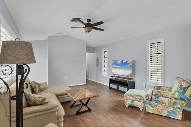 living room featuring ceiling fan, dark wood-type flooring, and lofted ceiling