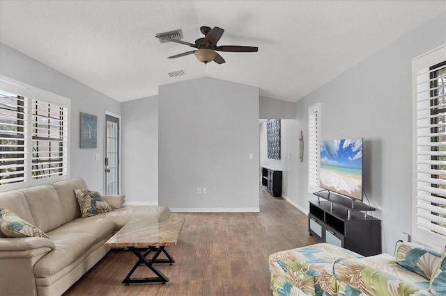 living room featuring ceiling fan, plenty of natural light, and lofted ceiling