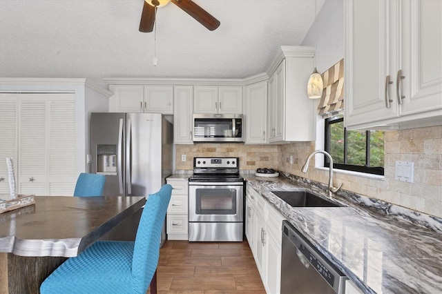 kitchen with sink, white cabinets, and stainless steel appliances