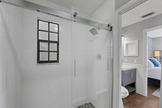 bathroom with vanity, toilet, and a shower with shower door