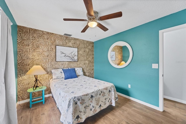 bedroom with hardwood / wood-style flooring and ceiling fan