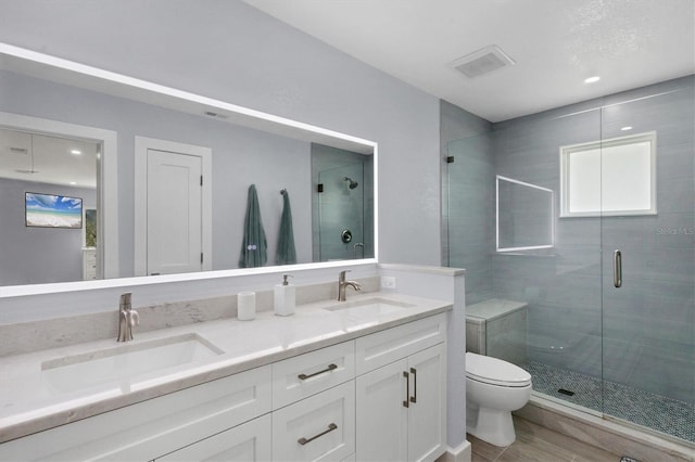 bathroom featuring vanity, toilet, and walk in shower