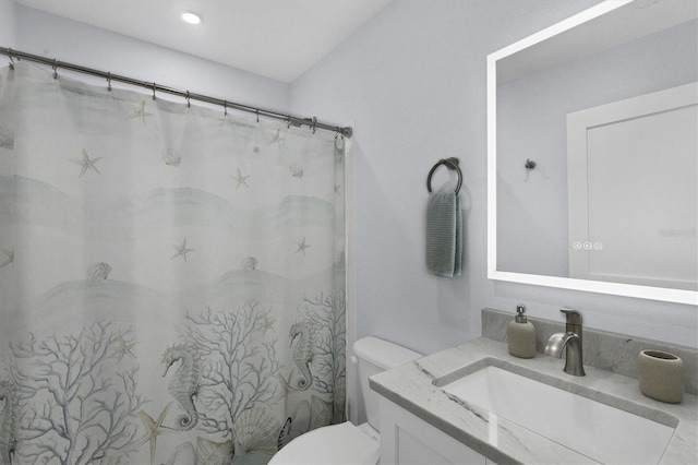 bathroom featuring toilet and vanity