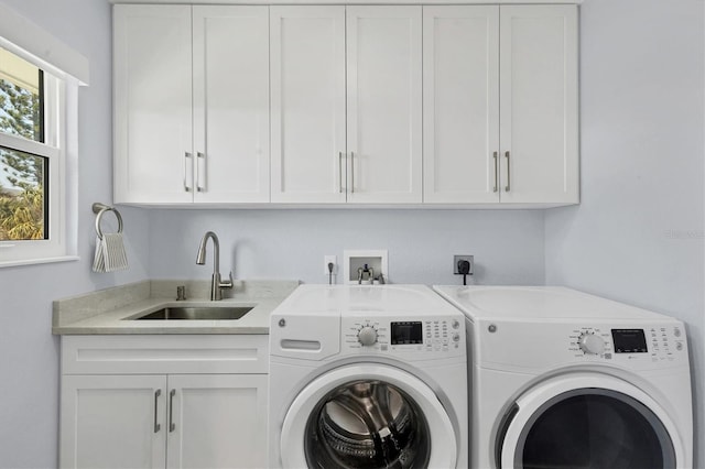 washroom featuring cabinets, washer and dryer, and sink