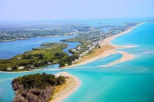 drone / aerial view featuring a water view and a view of the beach