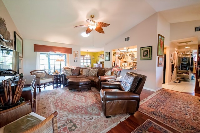 living room with light wood-type flooring, vaulted ceiling, and ceiling fan