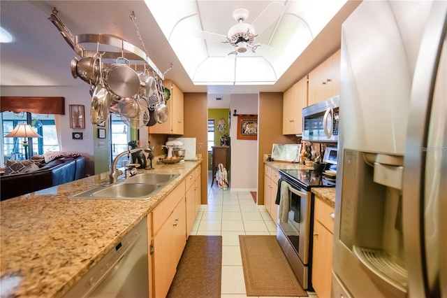 kitchen featuring ceiling fan, light tile patterned flooring, sink, and stainless steel appliances