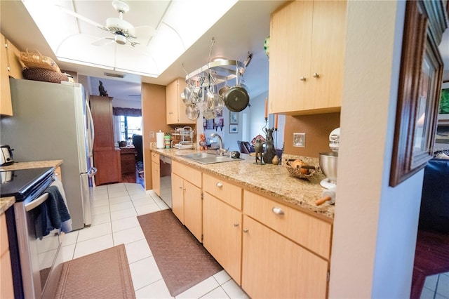 kitchen with electric range oven, ceiling fan, sink, light brown cabinets, and light tile patterned floors