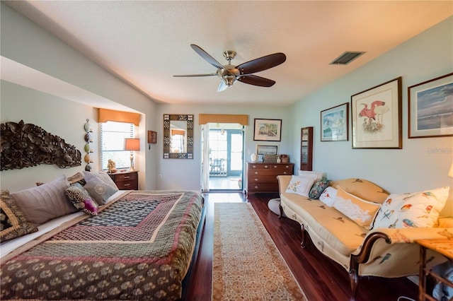 bedroom with access to exterior, dark hardwood / wood-style floors, and ceiling fan