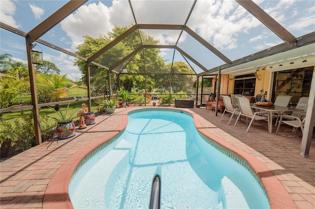 view of swimming pool featuring a lanai and a patio area