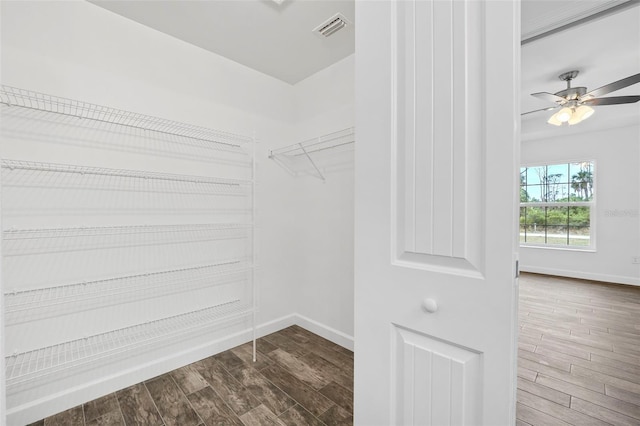 spacious closet with ceiling fan and hardwood / wood-style flooring