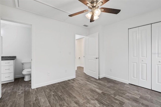 unfurnished bedroom with ceiling fan, a closet, and connected bathroom