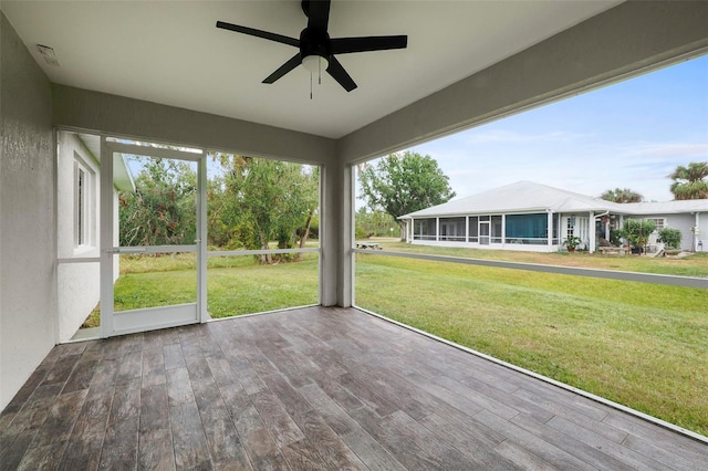 unfurnished sunroom with ceiling fan