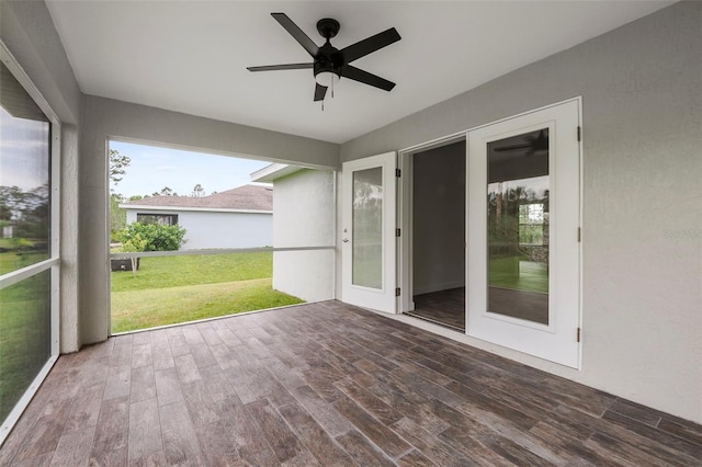 unfurnished sunroom with ceiling fan and french doors