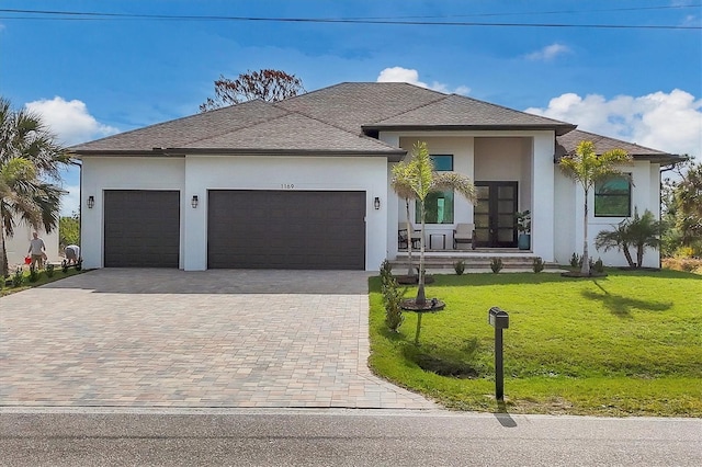 view of front of house with a garage and a front yard