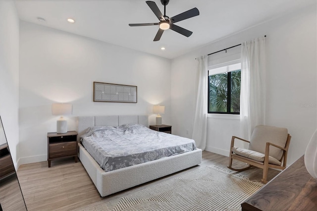 bedroom with ceiling fan and light wood-type flooring