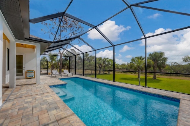 view of swimming pool featuring a lanai, a lawn, and a patio