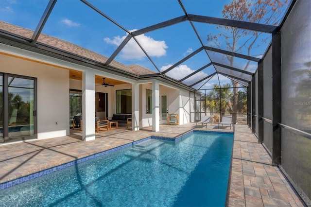 view of swimming pool with a lanai, an outdoor hangout area, ceiling fan, and a patio area