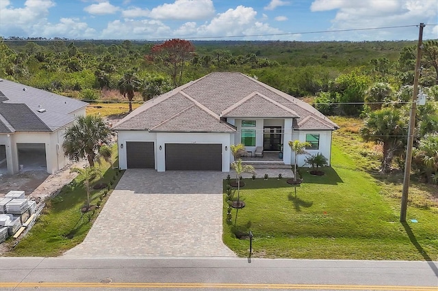 view of front facade with a garage and a front lawn