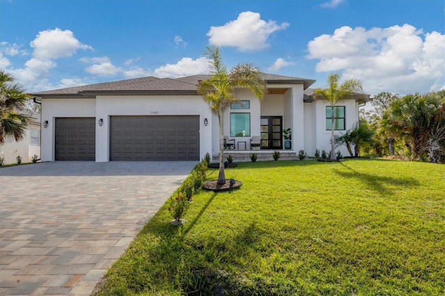 view of front of property with a garage and a front yard