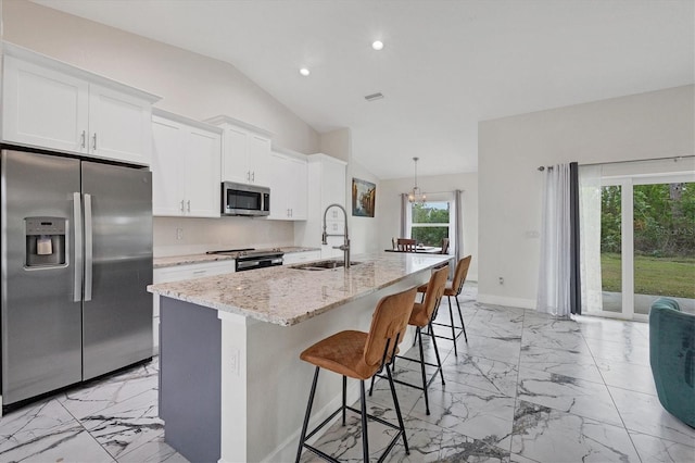 kitchen with white cabinetry, stainless steel appliances, a center island with sink, and sink