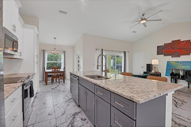 kitchen featuring white cabinets, appliances with stainless steel finishes, lofted ceiling, sink, and ceiling fan