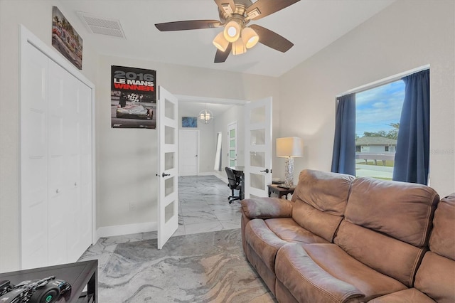 living room featuring ceiling fan and french doors