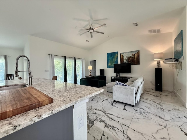 11247 Euler Ave, Englewood, FL 34224 - living area with a ceiling fan, lofted ceiling, light marble finish flooring, and baseboards