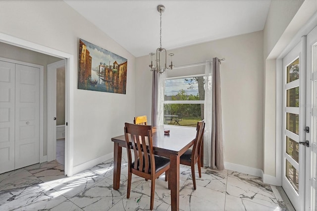 11247 Euler Ave, Englewood, FL 34224 - dining area with a chandelier, light marble finish flooring, plenty of natural light, baseboards, and vaulted ceiling