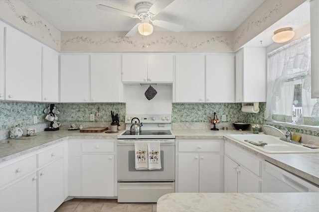 kitchen with white appliances, white cabinets, sink, ceiling fan, and a textured ceiling