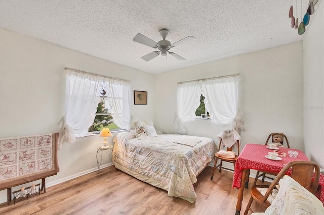 bedroom featuring a textured ceiling, hardwood / wood-style flooring, and ceiling fan