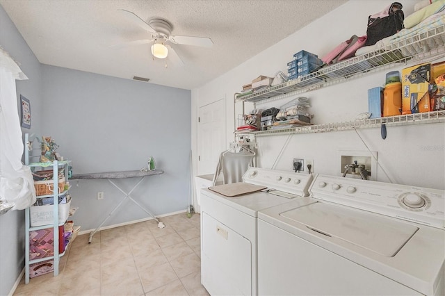 laundry room featuring washer and dryer, a textured ceiling, and ceiling fan