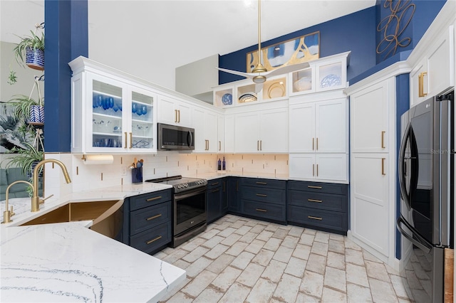 kitchen with white cabinetry, sink, hanging light fixtures, tasteful backsplash, and appliances with stainless steel finishes