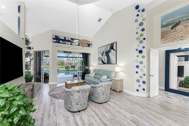 living room featuring light hardwood / wood-style flooring and lofted ceiling