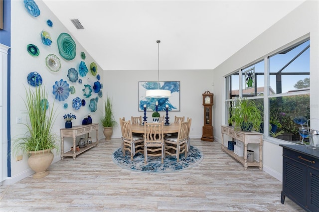 dining space with light hardwood / wood-style flooring