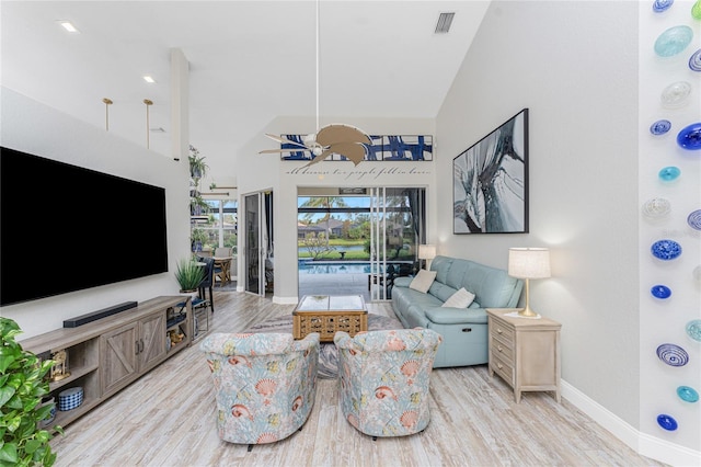 living room with light hardwood / wood-style floors and lofted ceiling