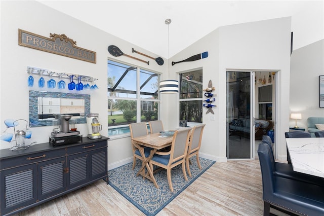 dining area featuring light hardwood / wood-style flooring and lofted ceiling