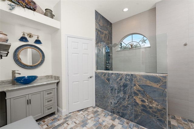 bathroom featuring vanity and tiled shower