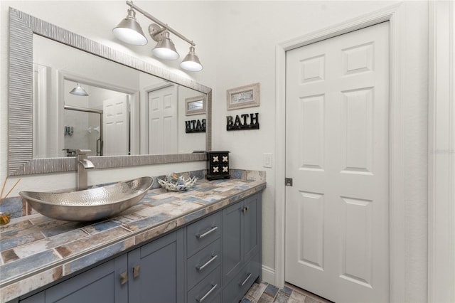 bathroom with vanity and a shower