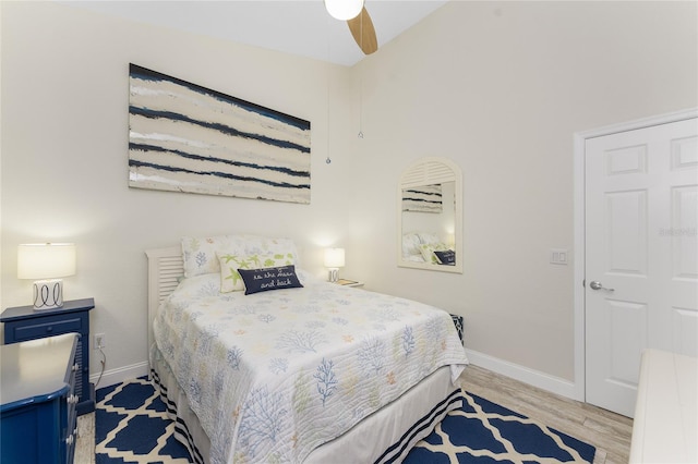 bedroom with light hardwood / wood-style floors and ceiling fan